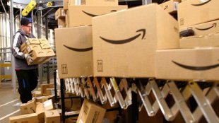 An Amazon employee sorts boxes before loading them onto trucks for shipping at Amazon.com's fulfillment Center in Fernley, Nevada.