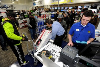 FILE - inside Nov. 29, 2013, file image, most useful Buy staff member Christopher Gervais, correct, rings up a 32-inch LED TV in Dunwoody, Ga. Sales at U.S. shops dropped 3.1 % to .7 billion the week that concluded on Sunday, Dec. 22, 2013, compared to the same few days this past year, according to ShopperTrak, which monitors data at 40,000 places. (AP Photo/David Tulis, File)